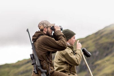 Two men looking for deer.