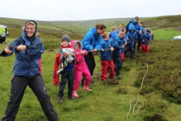 A group of children pulling a rope